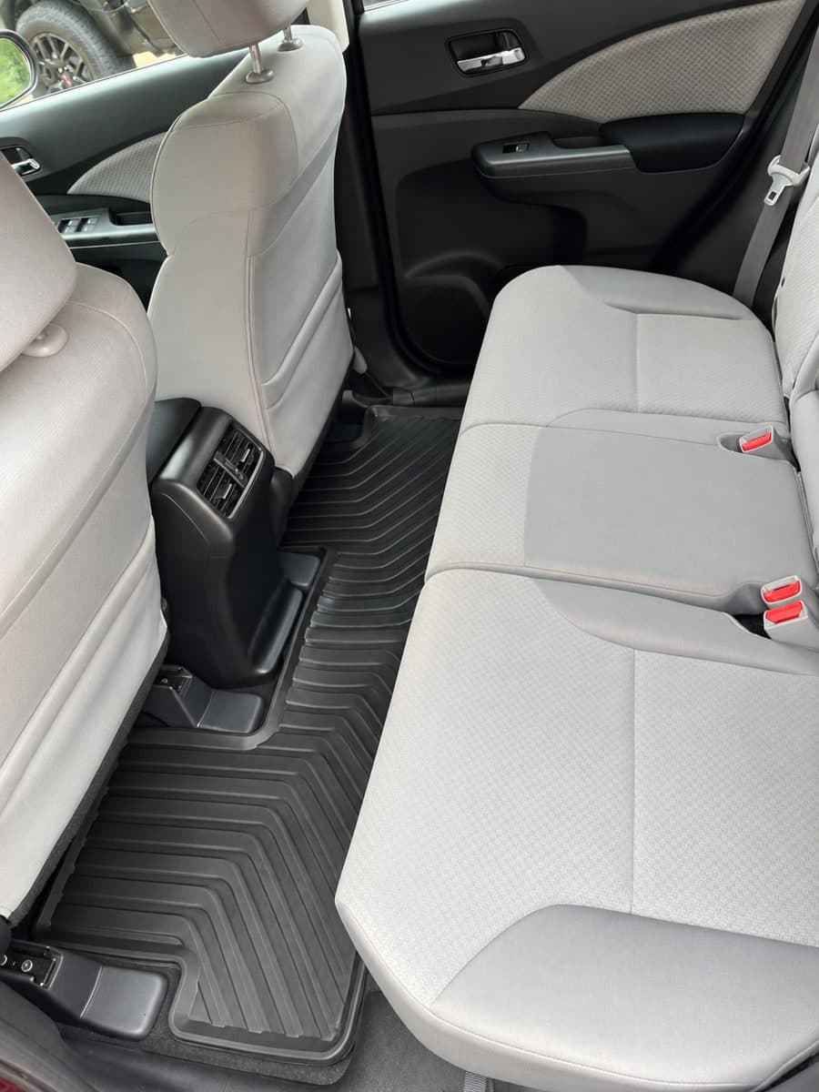 Same back seat after detailing, clean seat and floor mat